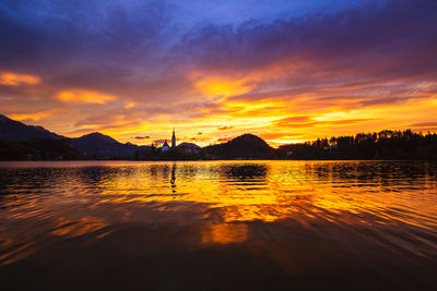 Scenic view of lake against orange sky