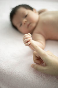 Close-up of baby lying on hand