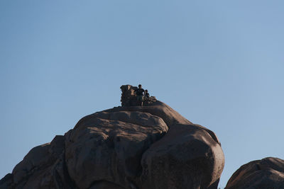 Low angle view of rock formation against clear sky