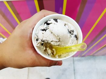 Close-up of hand holding ice cream