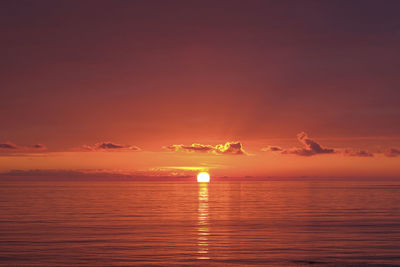 Scenic view of sea against romantic sky at sunset