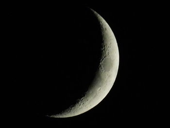 Low angle view of half moon against sky at night