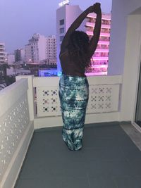 Rear view of woman standing on tiled floor