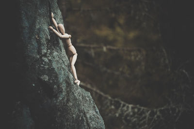 Close-up of man on rock at cliff