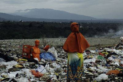 Rear view of friends on land against sky