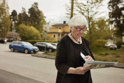 Senior woman holding newspaper