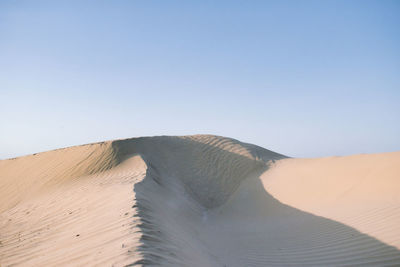 Scenic view of desert against clear sky