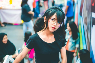 Portrait of young woman standing outdoors