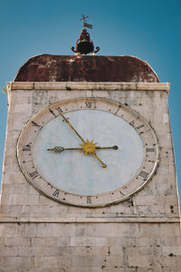 Low angle view of clock tower against old building