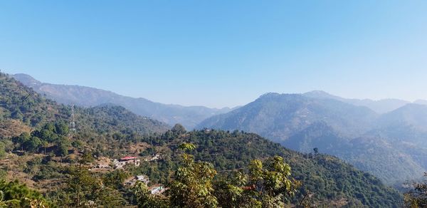 Scenic view of mountains against clear blue sky