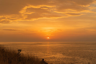 Scenic view of sea against romantic sky at sunset