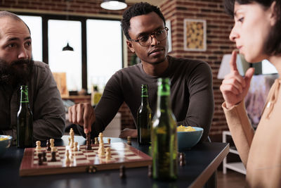 Colleagues discussing while playing chess