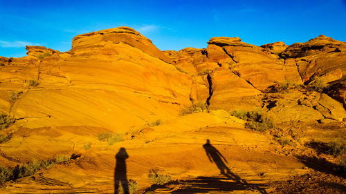 Shadow of people on rocky mountain