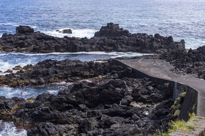 High angle view of rocks at sea shore