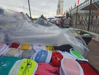 Close-up of multi colored umbrellas on street in city