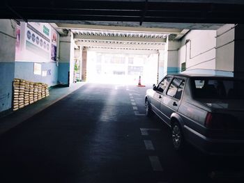 Empty road amidst buildings in city