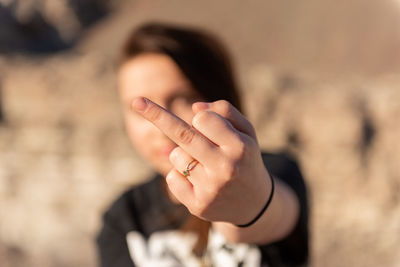 Close-up portrait of woman hand on blurred background