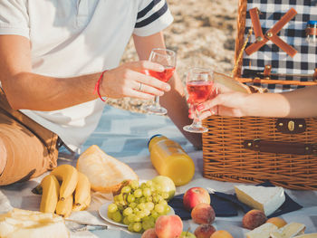 Midsection of people toasting drinks