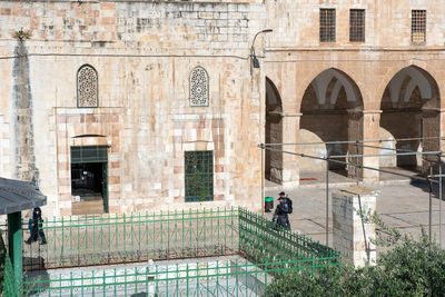 People in front of historic building