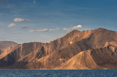 Scenic view of sea and mountains against sky