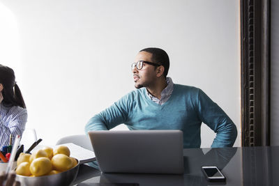 Businessman with laptop concentrating in meeting at office