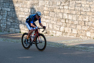 Man riding bicycle on road