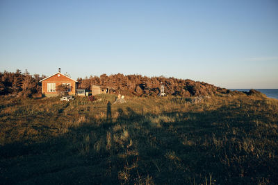 House on field against clear sky