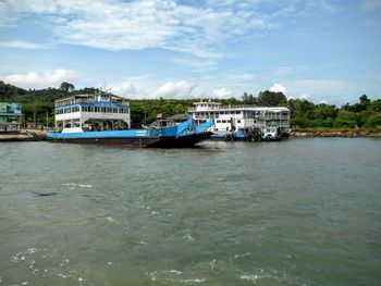 Boats in river with buildings in background