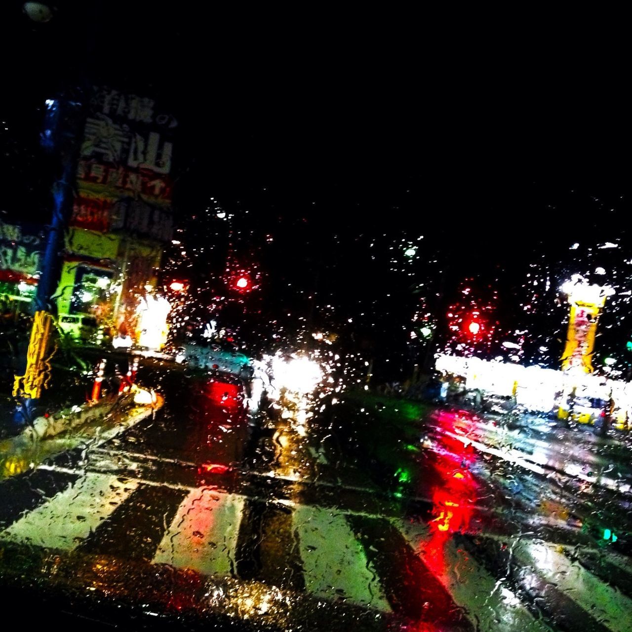 illuminated, night, wet, car, rain, city, transportation, drop, land vehicle, transparent, glass - material, window, traffic, street, road, mode of transport, city street, building exterior, architecture, city life