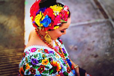 Woman in traditional clothing sitting outdoors