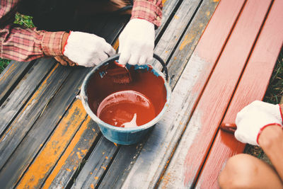 Low section of people holding coffee cup on table