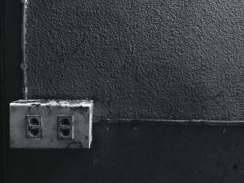 Close-up of electric switch board against wall