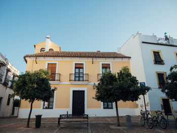 Street by building against clear sky