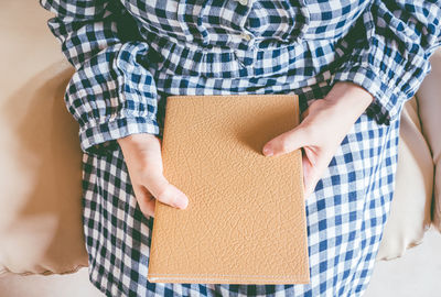 High angle view of woman standing against wall