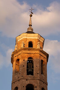 Low angle view of tower and building against sky