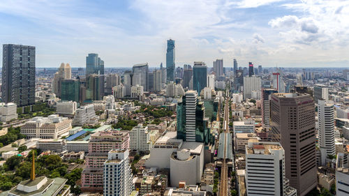 Aerial view of modern buildings in city against sky