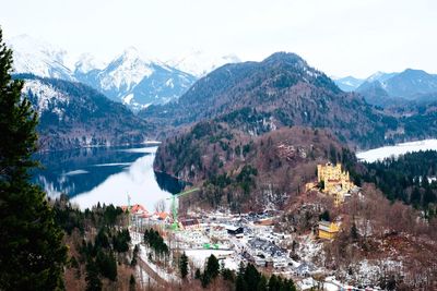 Scenic view of river and mountains against sky