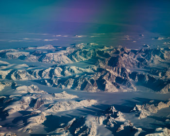 Aerial view of snowcapped mountains against sky