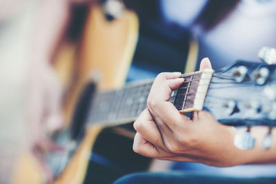 Cropped image of person playing guitar