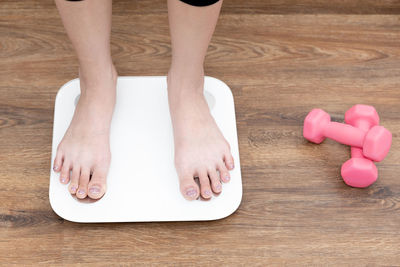 Low section of woman standing on floor