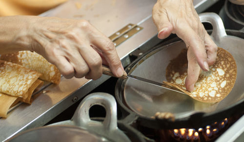 Cropped hands preparing food