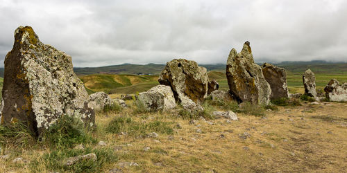 Panoramic view of rocks on landscape against sky