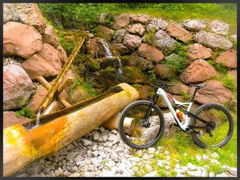 Bicycle parked on rock