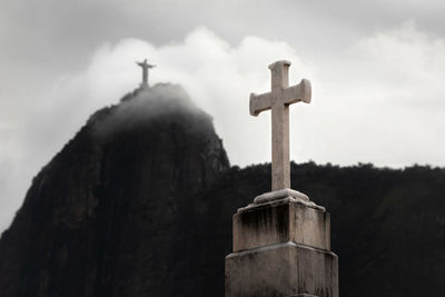 Low angle view of cross against sky