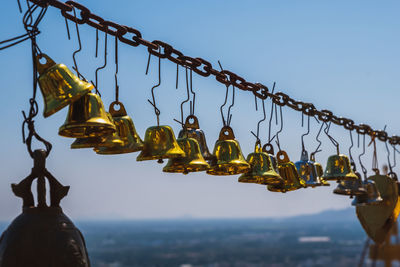 Low angle view of decorations hanging against sky