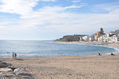 Scenic view of sea by city against sky