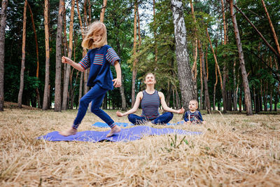 Parents and mental health. parents zen. little preschool daughter jumping while her mother doing