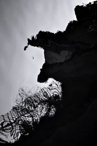 Low angle view of silhouette mountain against sky