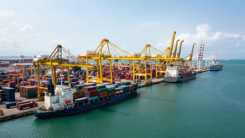 Containers ship and shipping ports cargo logistic freight load unloading by crane forwarding 