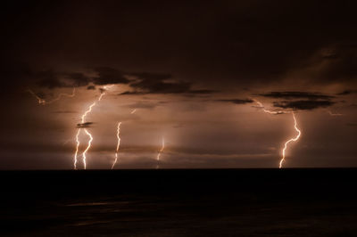 Lightning in sky over sea